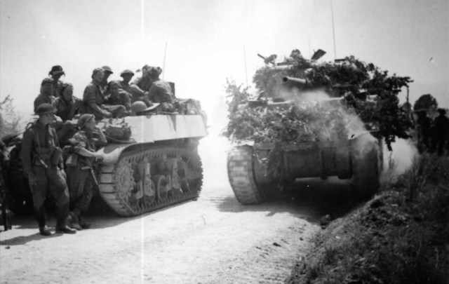 <p>Un carro da ricognizione viene superato da uno Sherman (Maggio 1944).</p>