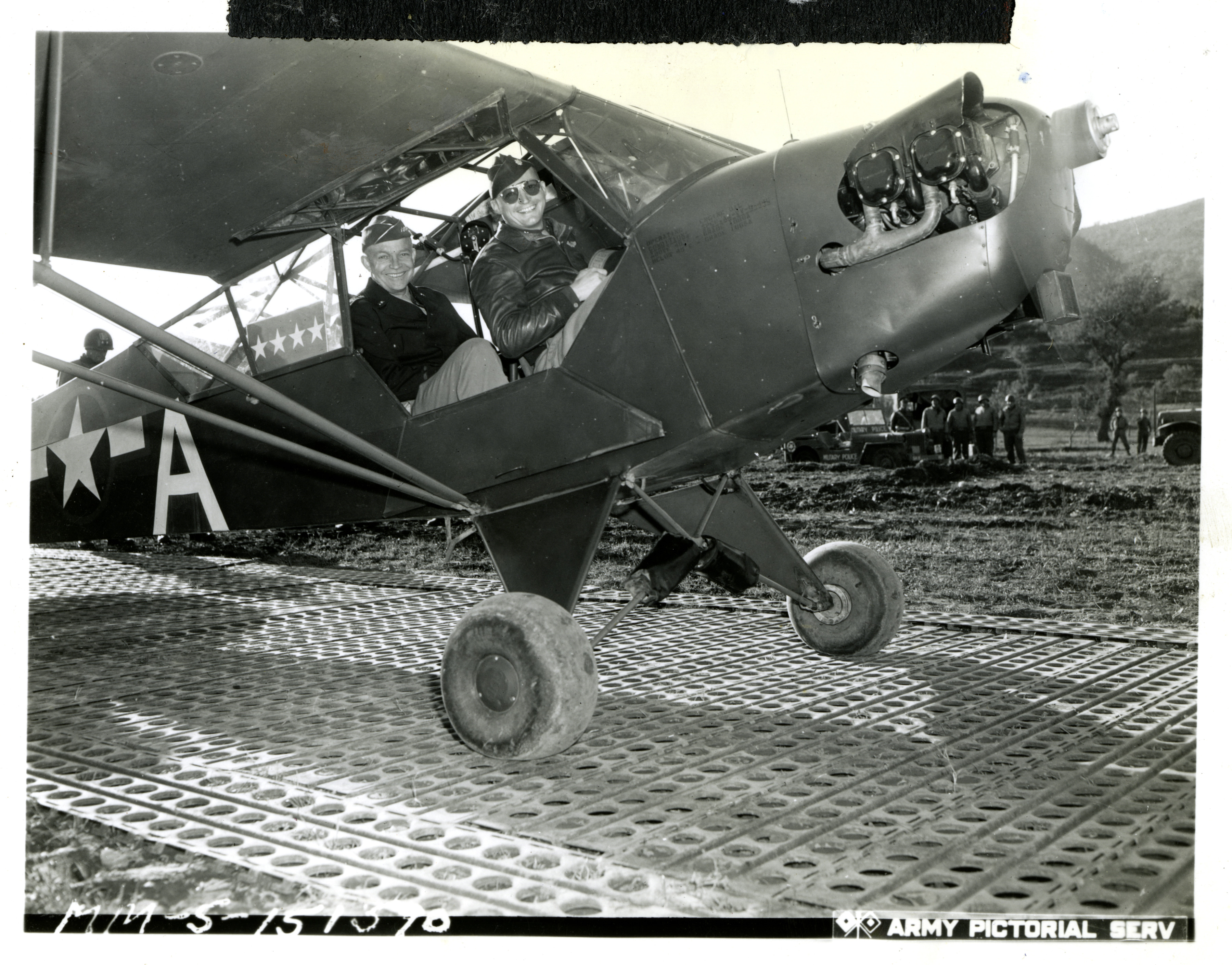 <p class='eng'>MM-5-151370; "Italy! General Eisenhower flies back from the fighting lines. The Commander-in-Chief, seated in rear of cockpit of the plane [Piper Cub] just before the take-off, had just completed a visit at the battlefront. Piloting the ship is Major T. J. Walker (right) of the Fifth Army." Confidential Sig. [Signal] Corps Photo 12-27-43." Italy. 27 December 1943.</p>
